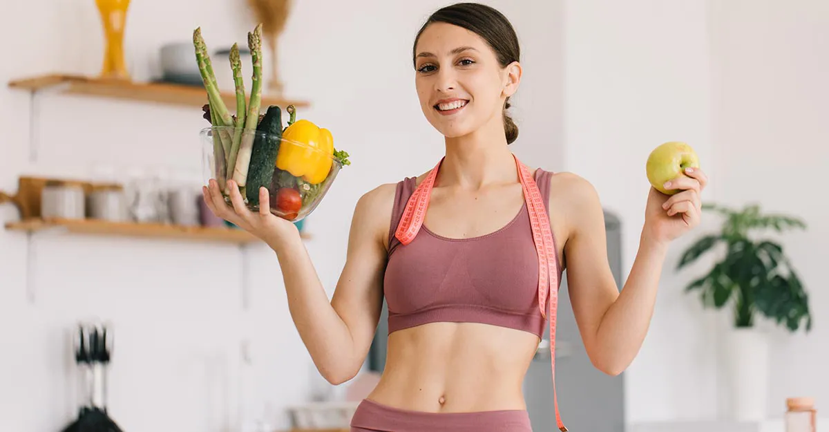 Healthy lifestyle, woman holding fruits and vegetables after working out