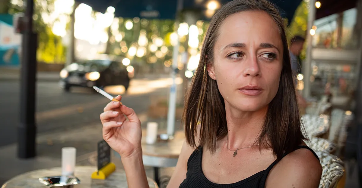 Woman smoking with aging skin
