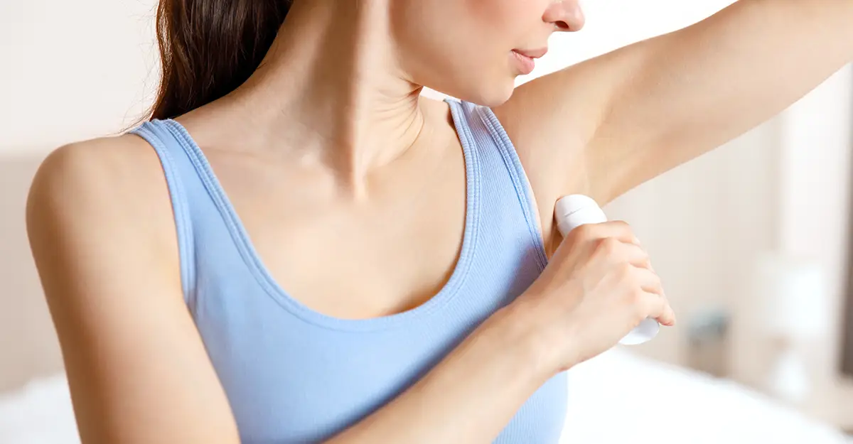 woman applying anti-perspirant