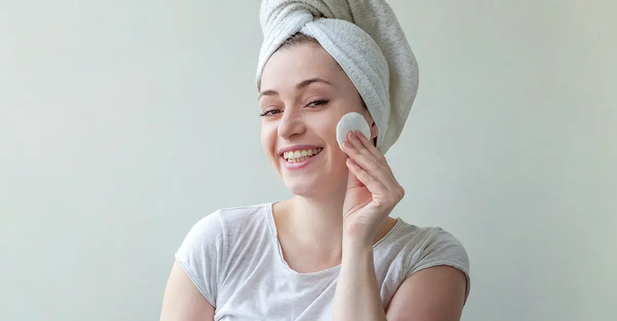 woman cleansing her face