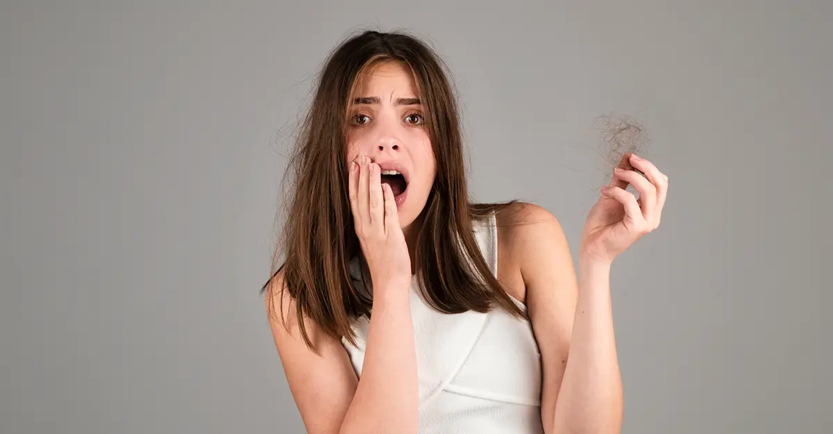 Signs of excessive hair loss, girl worried about damaged hair